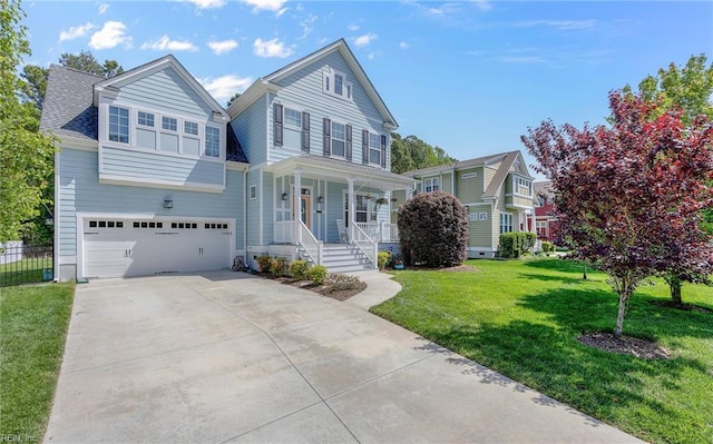 traditional home with covered porch, driveway, a front yard, fence, and an attached garage