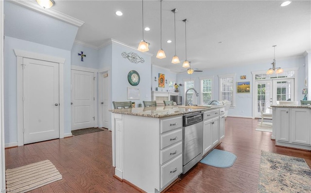 kitchen featuring ornamental molding, stainless steel dishwasher, and white cabinetry