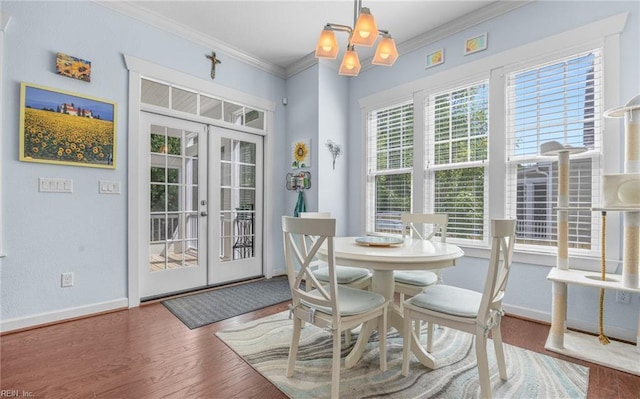 dining space with crown molding, baseboards, french doors, and wood finished floors