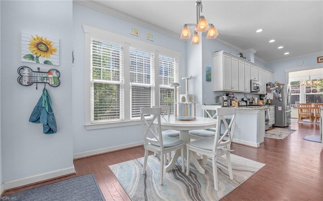 dining room with baseboards, ornamental molding, dark wood-type flooring, and a notable chandelier