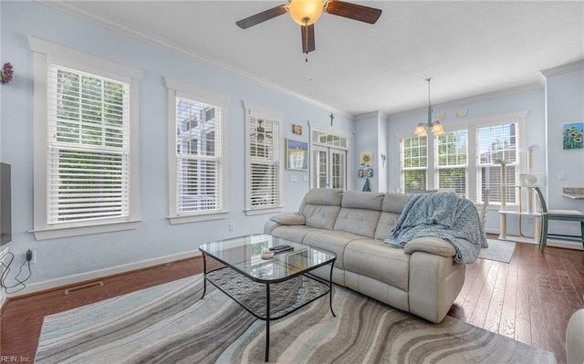 living area featuring a ceiling fan, visible vents, crown molding, wood finished floors, and baseboards