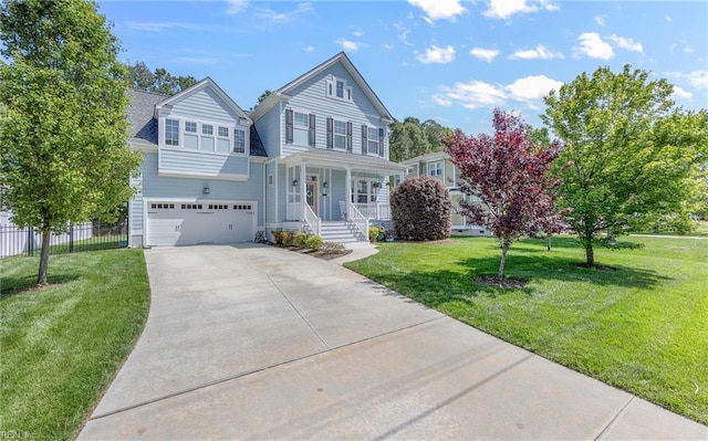 traditional-style home with covered porch, driveway, a front yard, a garage, and fence