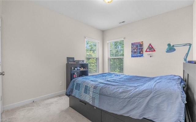 bedroom with baseboards, carpet floors, and visible vents