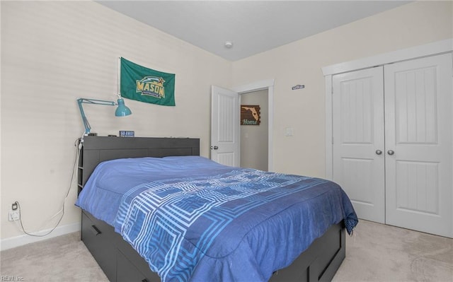 bedroom with a closet, carpet, and baseboards