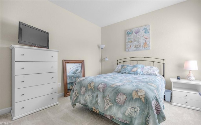 carpeted bedroom featuring baseboards