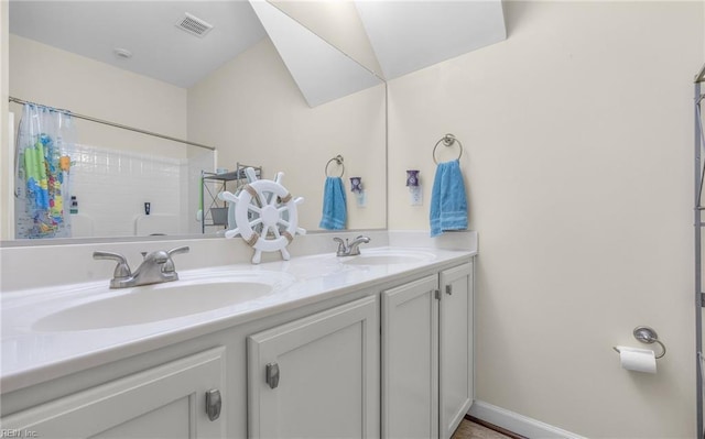 bathroom featuring a shower with shower curtain, double vanity, visible vents, and a sink