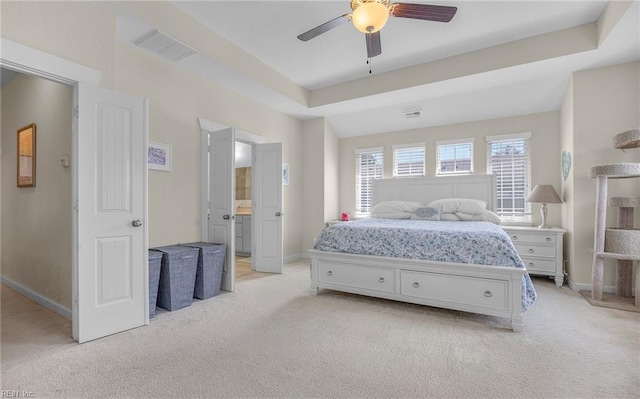 bedroom with visible vents, baseboards, and light carpet