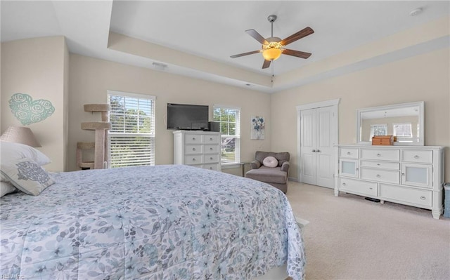 carpeted bedroom featuring a closet and a ceiling fan