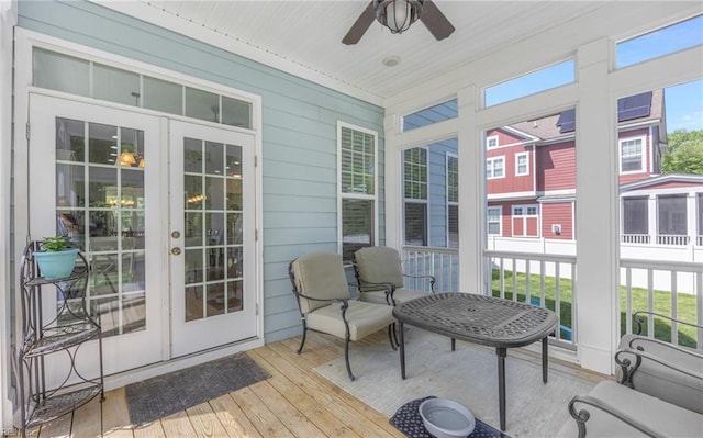 sunroom / solarium featuring french doors and ceiling fan
