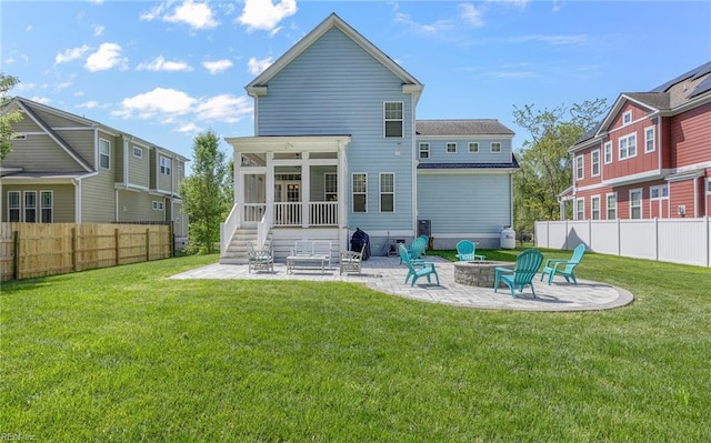 rear view of house featuring a patio, fence, a fire pit, and a sunroom