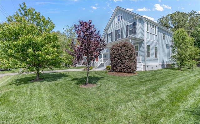 view of home's exterior featuring fence and a lawn
