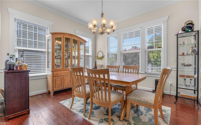 dining area featuring crown molding, visible vents, baseboards, dark wood-style floors, and a chandelier
