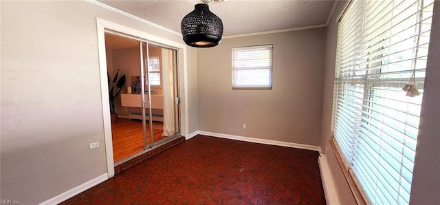 unfurnished room with baseboards, ornamental molding, and a baseboard heating unit