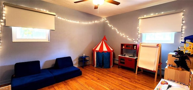 rec room featuring a ceiling fan and wood finished floors