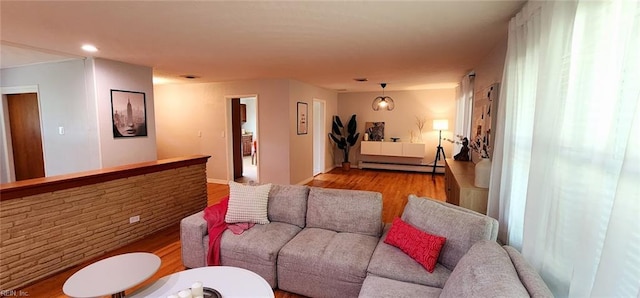 living area with recessed lighting, baseboards, wood finished floors, and baseboard heating