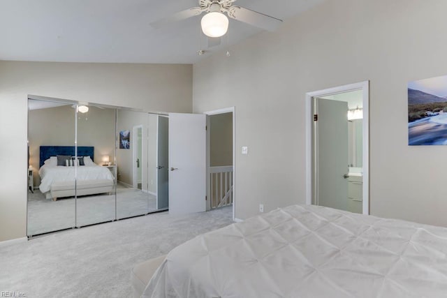 bedroom featuring ceiling fan, carpet floors, high vaulted ceiling, a closet, and ensuite bath