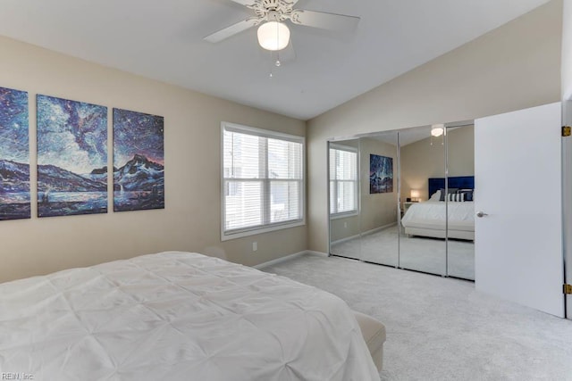 carpeted bedroom with a closet, a ceiling fan, and vaulted ceiling
