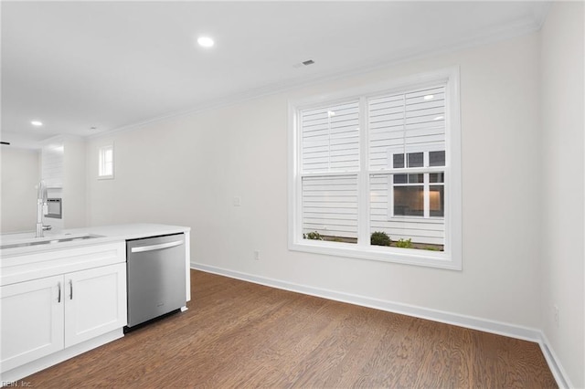 kitchen featuring dark wood-style flooring, dishwasher, a sink, white cabinets, and ornamental molding