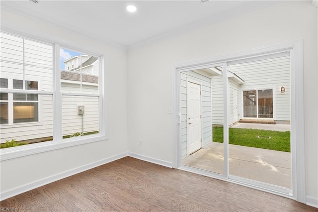 unfurnished room featuring baseboards, ornamental molding, recessed lighting, and wood finished floors