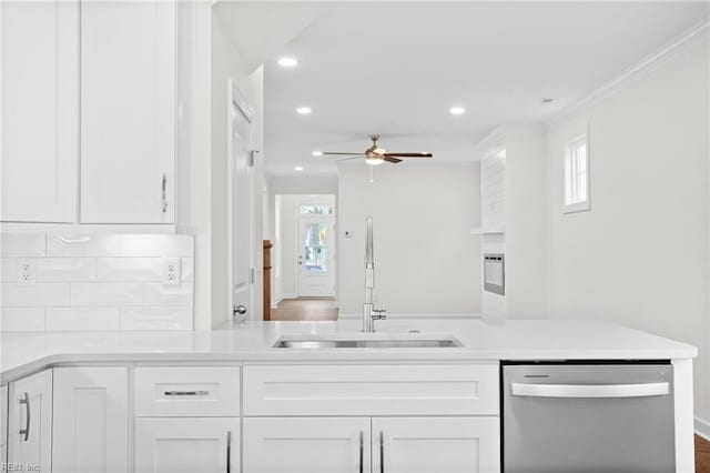 kitchen featuring a ceiling fan, dishwasher, a sink, light countertops, and white cabinets