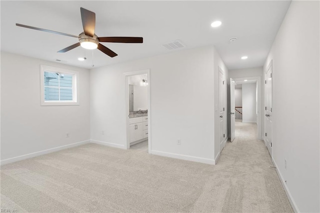 unfurnished bedroom with baseboards, light carpet, and recessed lighting