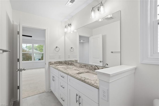 bathroom featuring a sink, double vanity, and visible vents