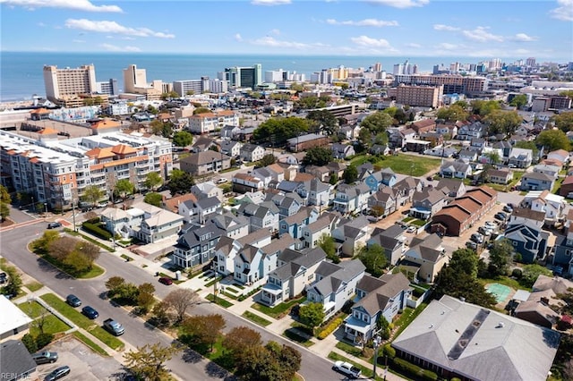 birds eye view of property with a view of city and a water view
