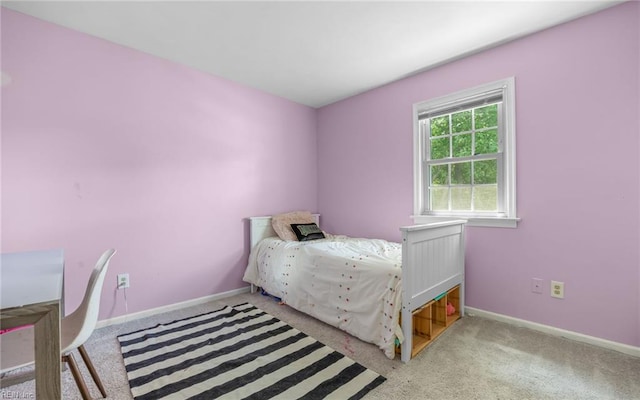 bedroom featuring carpet floors and baseboards