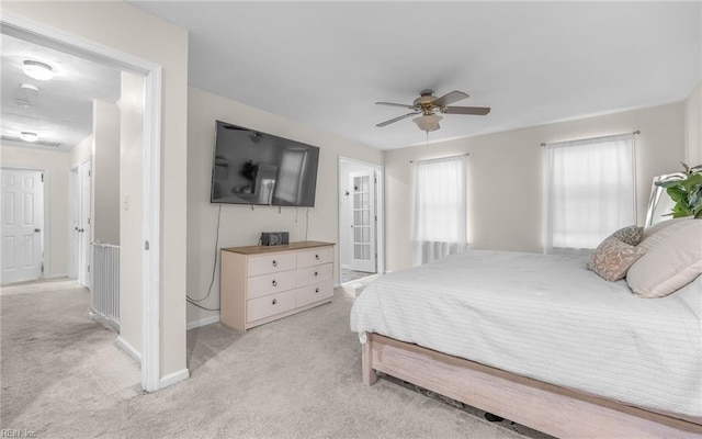 bedroom featuring baseboards, a ceiling fan, and light carpet