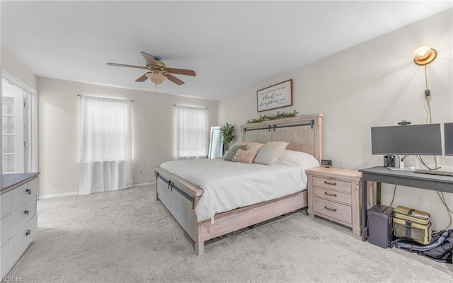bedroom with a ceiling fan, baseboards, and light colored carpet