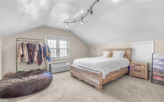 carpeted bedroom featuring lofted ceiling and a wall mounted air conditioner