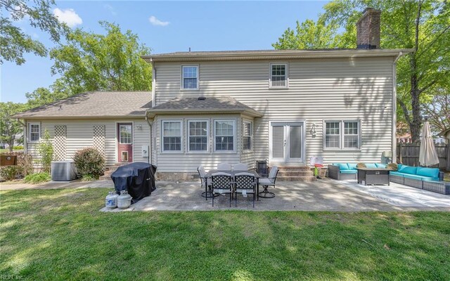 rear view of property with a chimney, a lawn, a patio, outdoor lounge area, and entry steps
