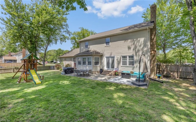 rear view of property with a lawn, a fenced backyard, a patio area, and entry steps