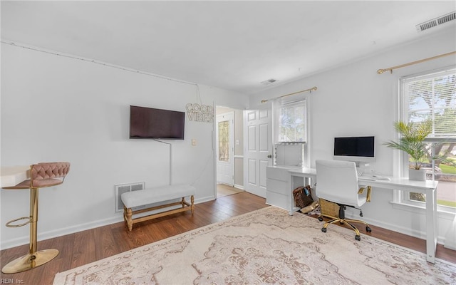 home office featuring visible vents, plenty of natural light, and wood finished floors
