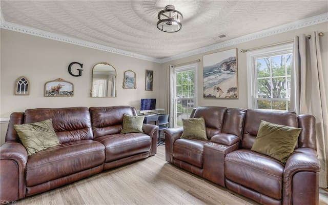 living room featuring crown molding, wood finished floors, and visible vents
