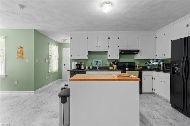 kitchen featuring a center island, white cabinets, under cabinet range hood, and black appliances