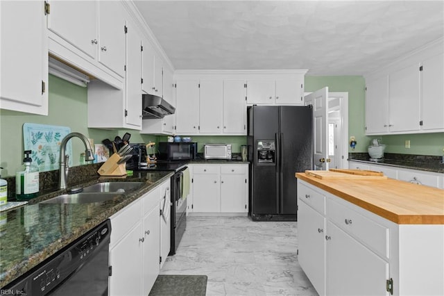 kitchen with white cabinets, a sink, marble finish floor, under cabinet range hood, and black appliances
