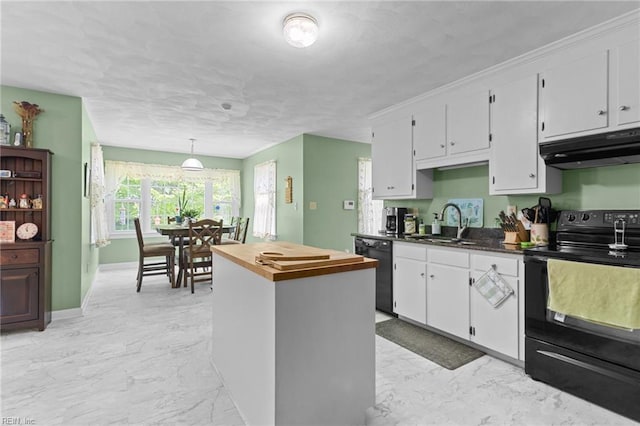 kitchen featuring white cabinets, a sink, marble finish floor, under cabinet range hood, and black appliances