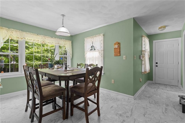 dining area featuring baseboards