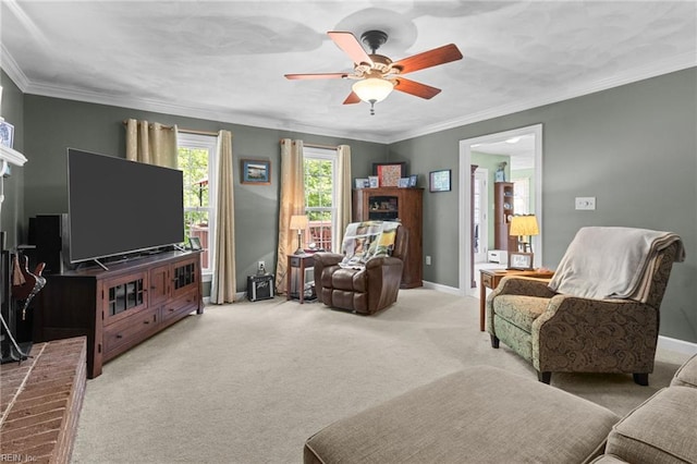 living room with crown molding, baseboards, ceiling fan, and light carpet