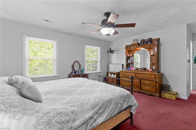 bedroom with carpet floors, ceiling fan, baseboards, and visible vents