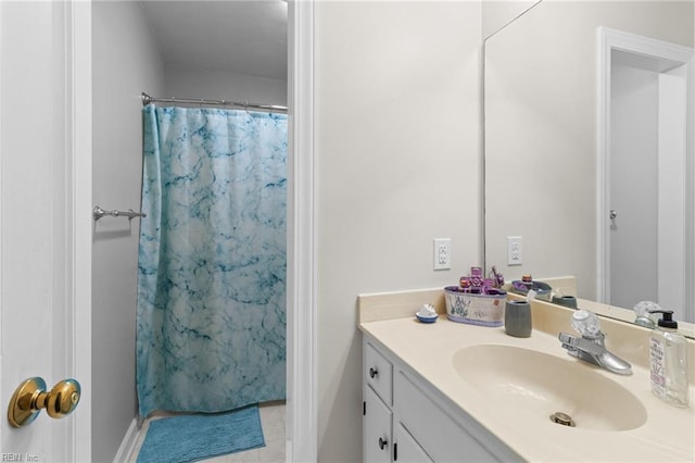 full bathroom with vanity, baseboards, a shower with curtain, and tile patterned floors