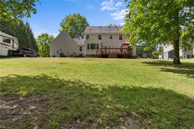 rear view of house featuring a wooden deck, a yard, and crawl space