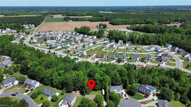 drone / aerial view with a residential view and a view of trees