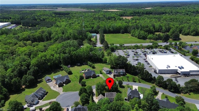 birds eye view of property featuring a view of trees
