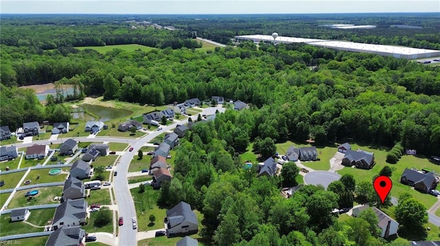 birds eye view of property with a residential view, a water view, and a wooded view