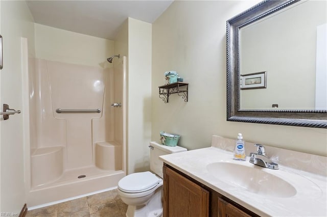 full bath with vanity, walk in shower, and toilet