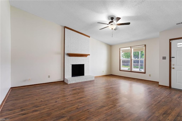 unfurnished living room featuring a textured ceiling, a ceiling fan, baseboards, wood finished floors, and visible vents