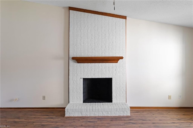 room details with baseboards, wood finished floors, and a fireplace
