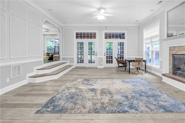 sunroom with a healthy amount of sunlight, french doors, and visible vents